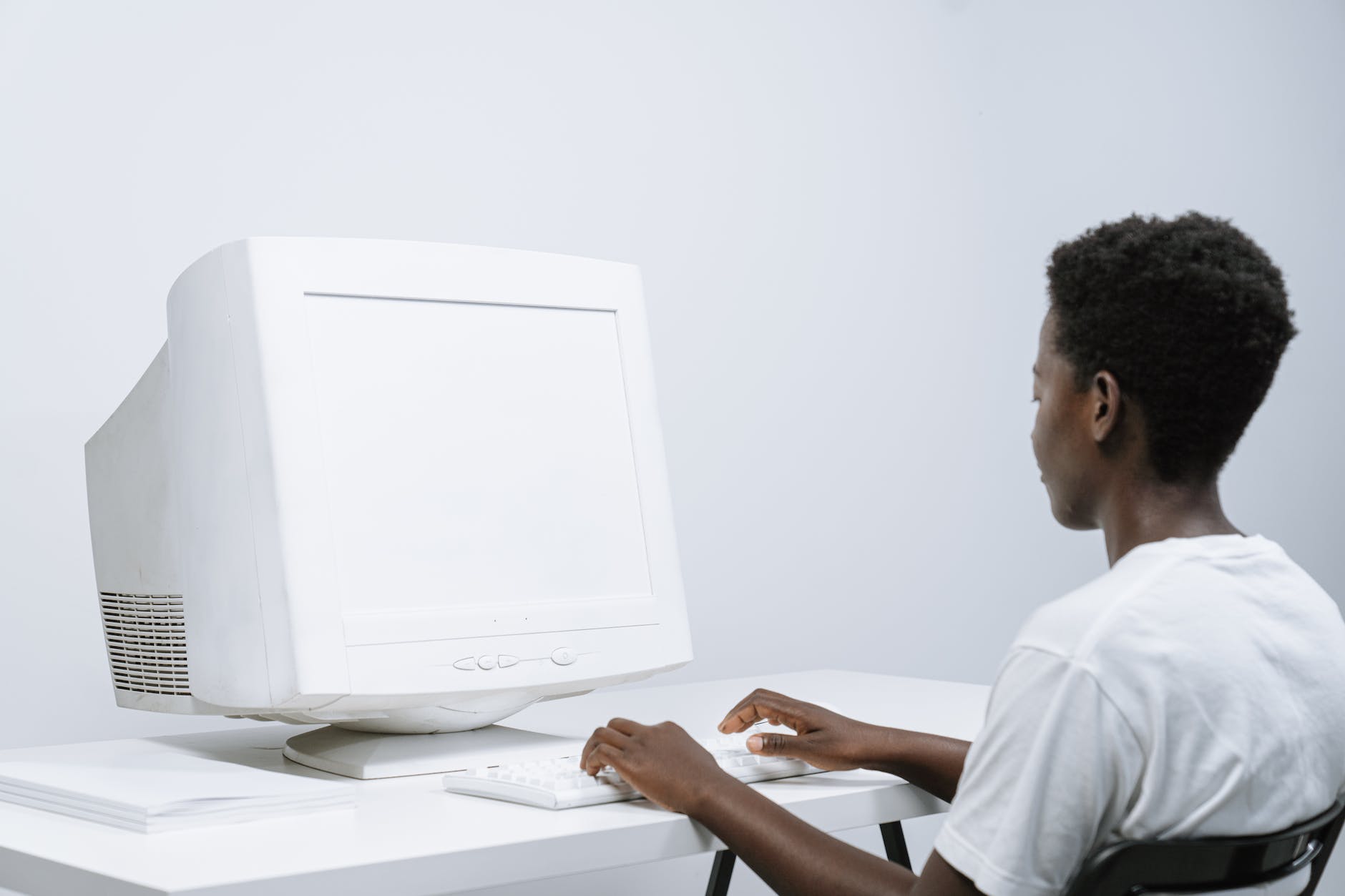 person in white crew neck t shirt using a computer